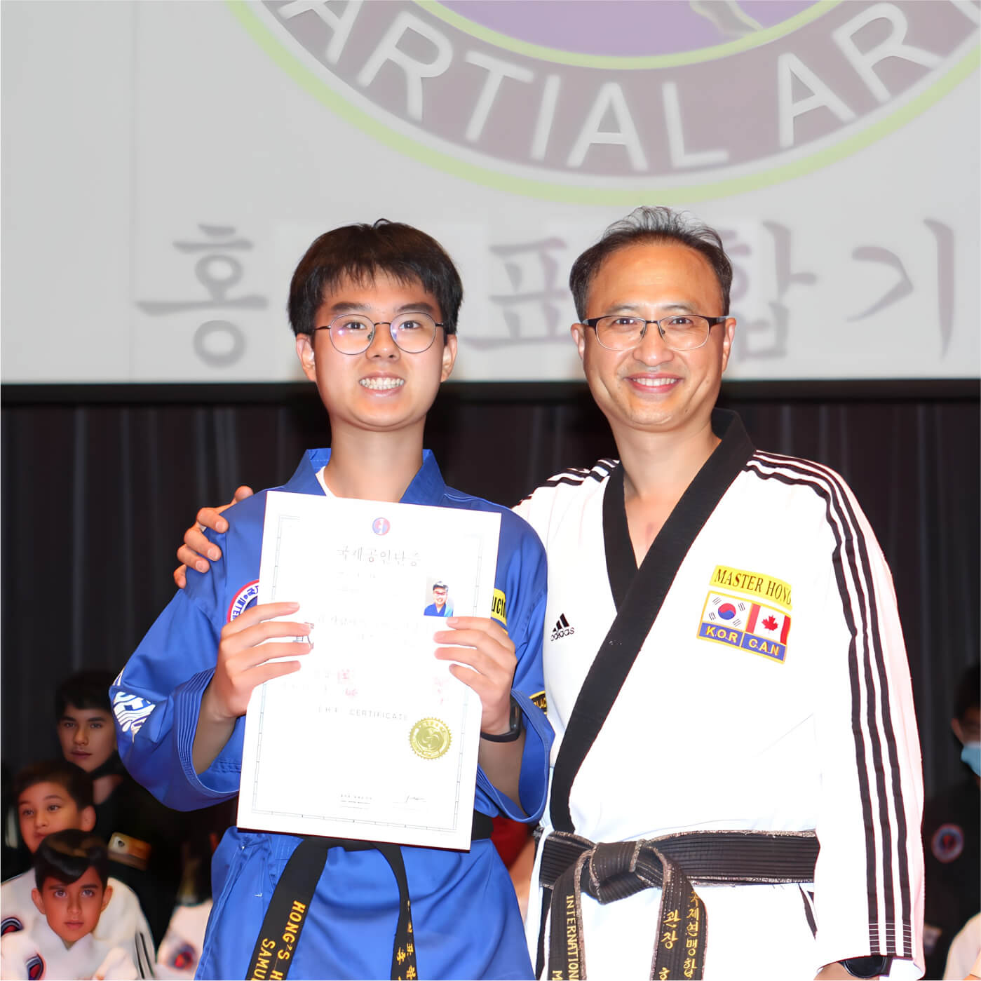 happy student graduation Hong's hapkido school of martial arts in Port Moody Maple Ridge Vancouver Canada